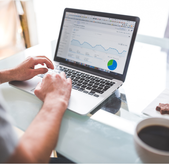 Person analyzing business data on a laptop